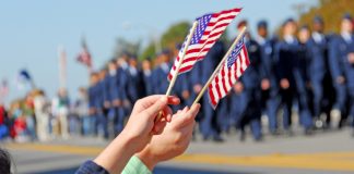 Hands holding flags at a parade event