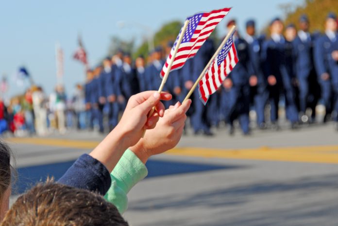 229799434 featured image Hands holding flags at a parade event