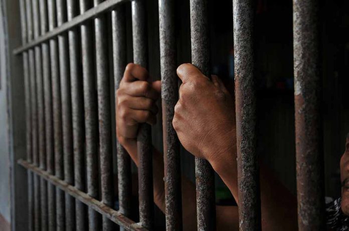2452368639 featured image Hands gripping prison cell bars tightly