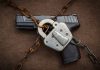 Handgun secured with chains and a padlock