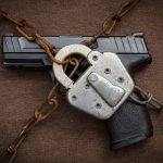 Handgun secured with chains and a padlock