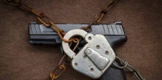 Handgun secured with chains and a padlock