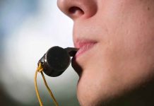 Person holding a whistle in their mouth