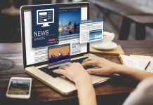 Person reading news websites on a laptop
