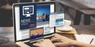 Person reading news websites on a laptop