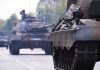 Tanks on a road with soldiers inside