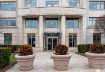 Large building entrance with three potted plants