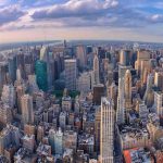 Aerial view of city with skyscrapers and cloudy sky