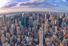 Aerial view of city with skyscrapers and cloudy sky
