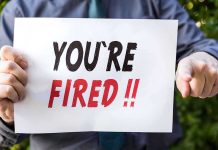 Person holding YOU ARE FIRED sign