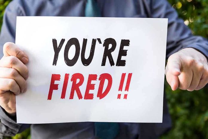 Person holding YOU ARE FIRED sign