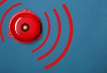 Red alarm bell on a blue background