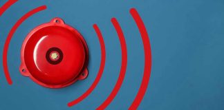 Red alarm bell on a blue background