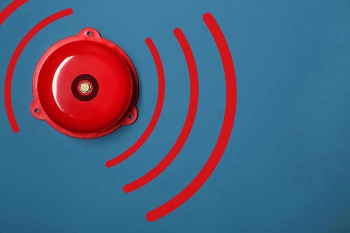 Red alarm bell on a blue background