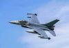 Jet fighter flying through clear blue sky