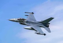 Jet fighter flying through clear blue sky