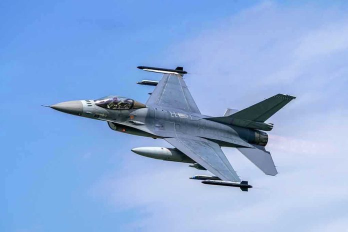 Jet fighter flying through clear blue sky