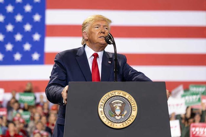 1677446164 Man speaks at podium with U.S. flag background.