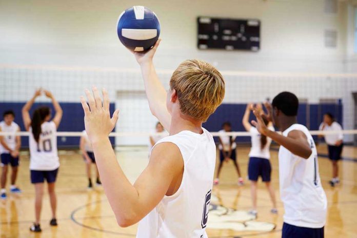 198896267 Players about to serve a volleyball in gym.