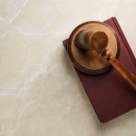 Gavel resting on a closed book.