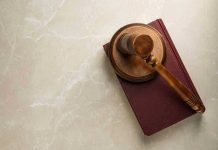 Gavel resting on a closed book.