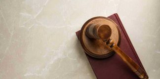Gavel resting on a closed book.
