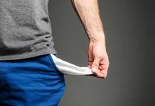 Person pulling out empty pocket from shorts