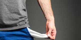 Person pulling out empty pocket from shorts