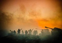 Soldiers and tanks in the foggy battlefield.