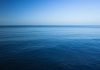 A calm ocean under a clear blue sky