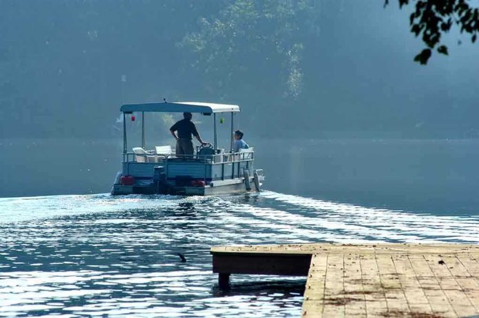 shutterstock_507843.jpg Two people on a boat navigating a misty lake