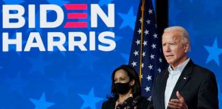 Two people speaking at a Biden Harris event.