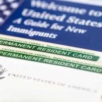 Permanent resident cards with welcome guide and flag.