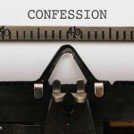 Typewriter typing the word confession on paper