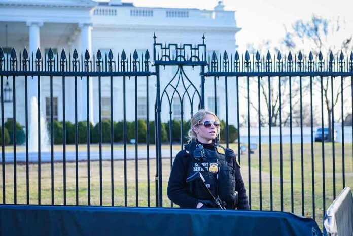 1435108799 Secret Service agent stands guard outside the White House.