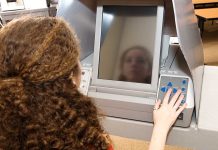 A person using an electronic voting machine at a polling station
