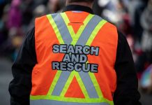 Blizzard Traps 24—Rescue Teams RACE Against Time Person wearing a bright orange search and rescue vest