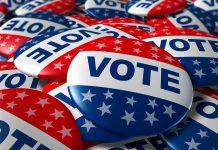 Ex-Husband’s Claim Rocks Governor’s Race – Records Released! A pile of colorful buttons with the word VOTE and stars, symbolizing election participation