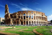 The Colosseum in Rome with tourists walking around it