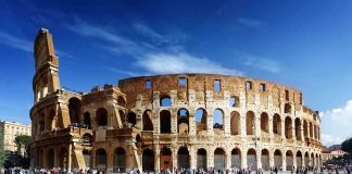 The Colosseum in Rome with tourists walking around it