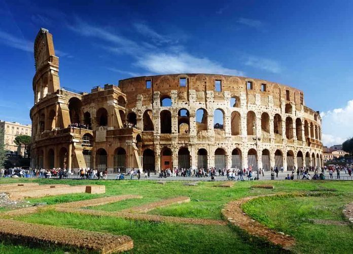The Colosseum in Rome with tourists walking around it
