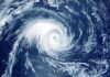 Mass Evacuation—Millions Flee Monster Storm Satellite image of a swirling hurricane over ocean.