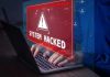 183 Million Passwords HACKED—Check Yours! Warning sign System Hacked on laptop screen.