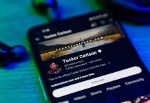 Tucker ATTACKS FBI: Assassination Cover-Up Clash Smartphone displaying a YouTube channel profile page.