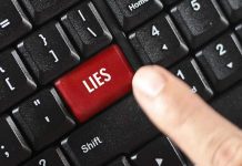 Finger pressing LIES key on keyboard.