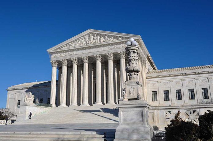 The Supreme Court building with large columns and a clear blue sky