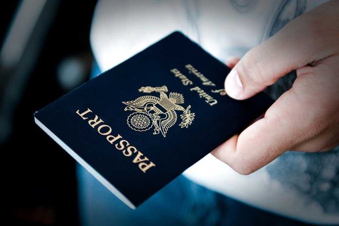 shutterstock_82796137.jpg A person holding a United States passport with a dark background