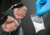 Fentanyl Chaos Hits Providence College Party Person handcuffed, police holding bag of white substance.