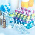 TrumpRx Unleashed: Big Pharma’s Nightmare Begins Vials and blister packs of pills on table.