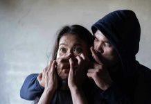 Father’s Instinct Saves Daughter From Knife-Wielding Kidnapper Man holding womans mouth, gesturing silence.